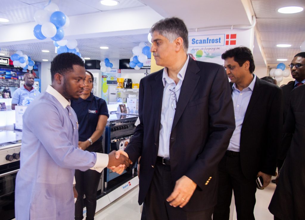 L-R: Oni Ayodele John, owner of Onaj Electronic, Mr. Sunil Gupte, Group CEO Fareast Mercantile Ltd. and the franchisee partner. Behind: Mr. Maneesh Nanda, MD for Scanfrost.